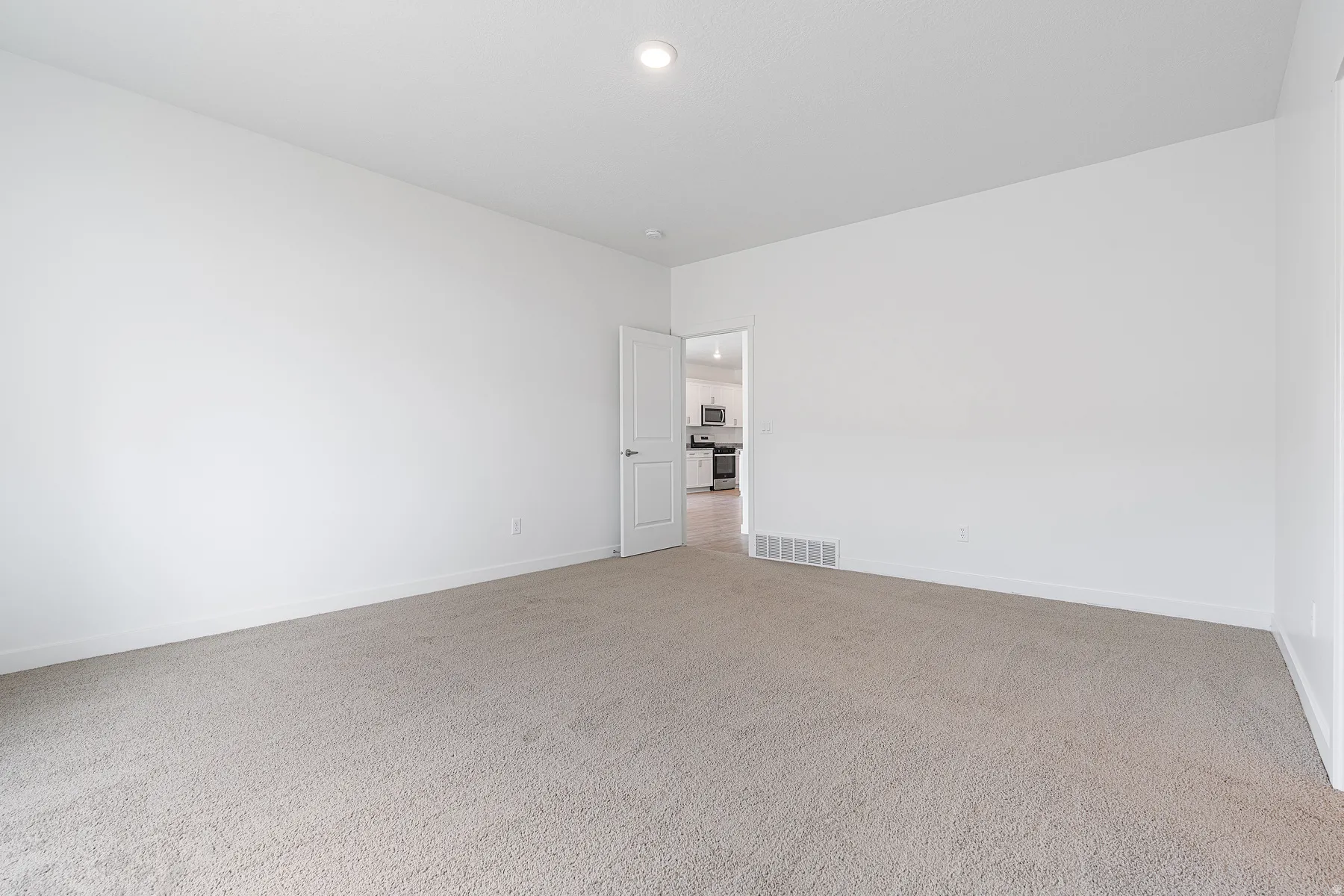 Spacious room with light-toned carpeting and neutral wall finishes