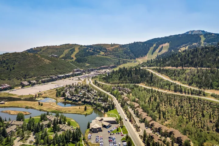 Mountainous topography with wooded areas and natural water features