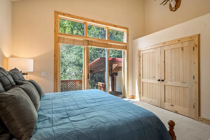 Primary Bedroom with Transom Windows and Custom Wood CabinetryBright primary bedroom showcasing expansive transom windows with wood framing that flood the space with natural light