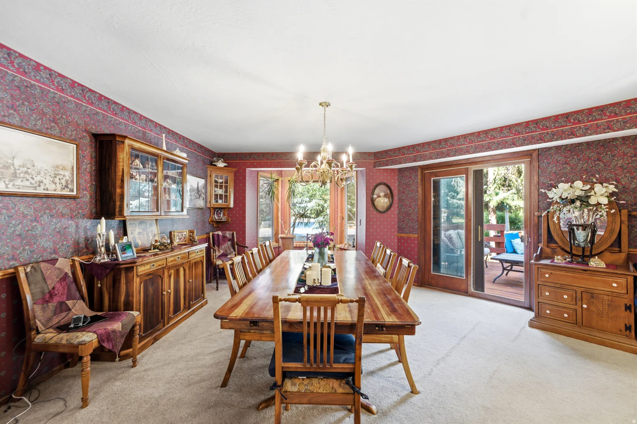 Recessed lighting illuminates the room, featuring a built-in wooden buffet with glass-front display cabinets