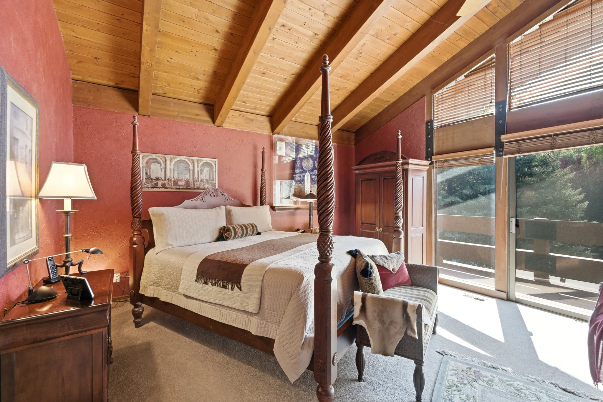 Primary with vaulted wood-paneled ceiling, full-height windows, a sliding glass door, and a private balcony