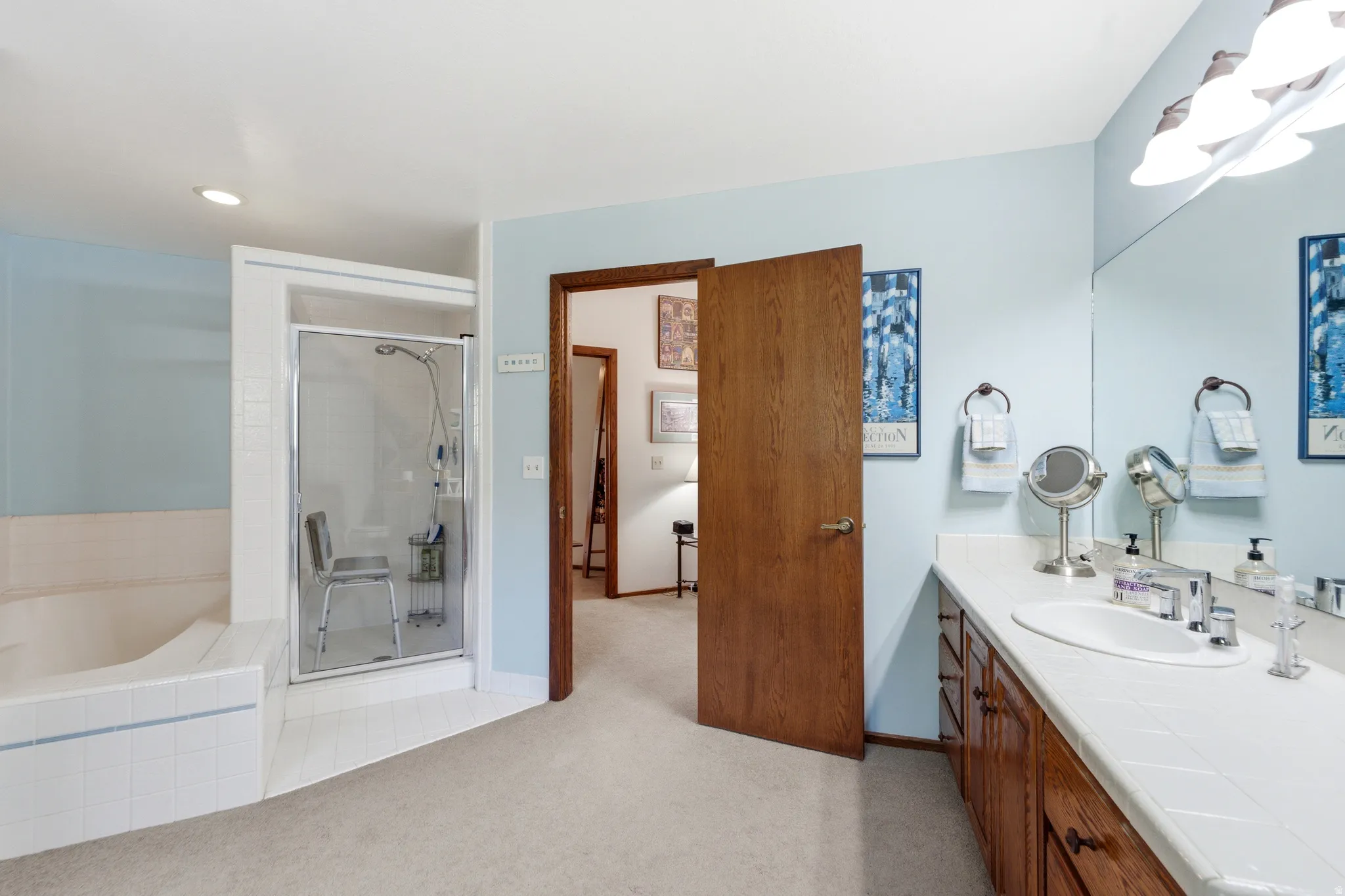 Bathroom on 2nd floor - Recessed lighting, wood-finish cabinetry, integrated vanity sink, tiled countertop, and a glass-enclosed shower