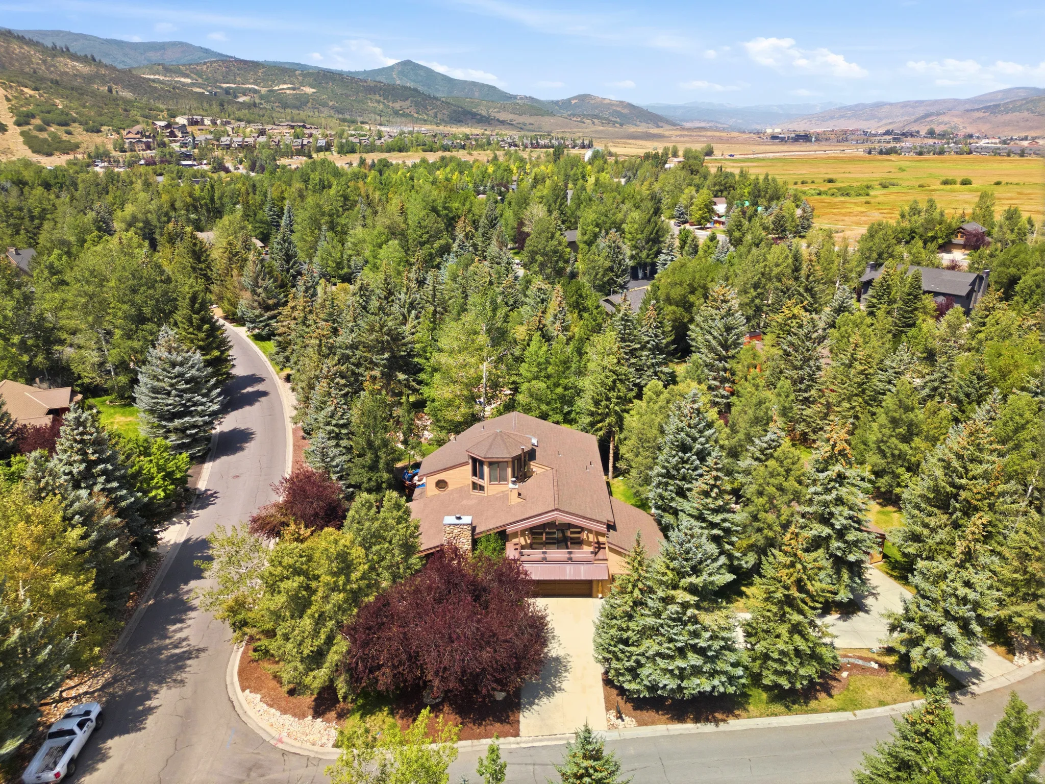 Mountainous valley setting featuring extensive mature trees