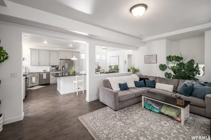 Open-concept living space with wood-finish flooring