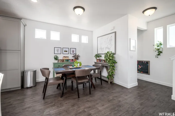 Wood-finish flooring throughout, light gray built-in cabinetry, and white painted walls