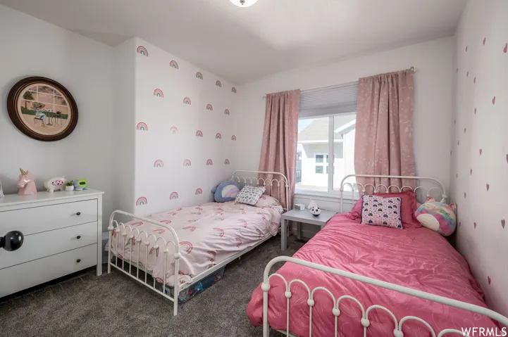 Recessed window with blinds and drapes, white walls, and gray carpet flooring