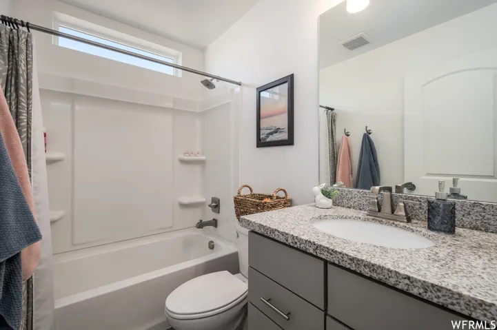 White tub and shower combination with a transom window