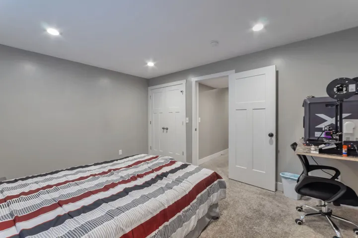 Spacious secondary bedroom featuring recessed ceiling lighting, carpeted flooring, and direct access to an ensuite bathroom