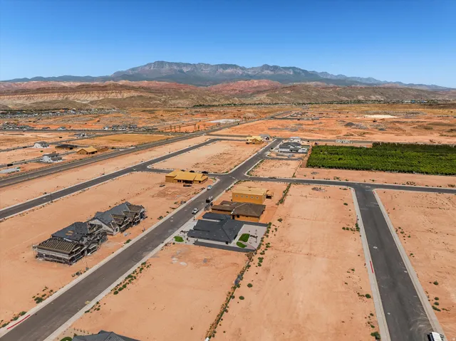 Expansive development land with paved roads and mountain backdrop