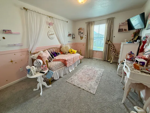 Wall-to-wall carpeting and a single window with blinds