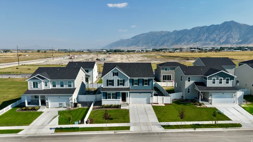 Striking new construction homes showcasing modern architectural design with two-story elevations, multi-car garages, and manicured front landscaping