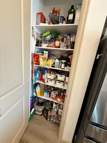 Built-in pantry shelving with durable wood-finish flooring