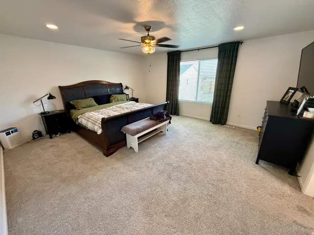 Master bedroom 17x16 ft. Recessed ceiling lighting, ceiling fan with integrated light fixture, carpeted flooring, and window with blinds
