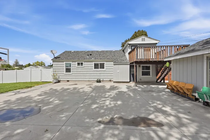 Expansive concrete patio with a detached structure