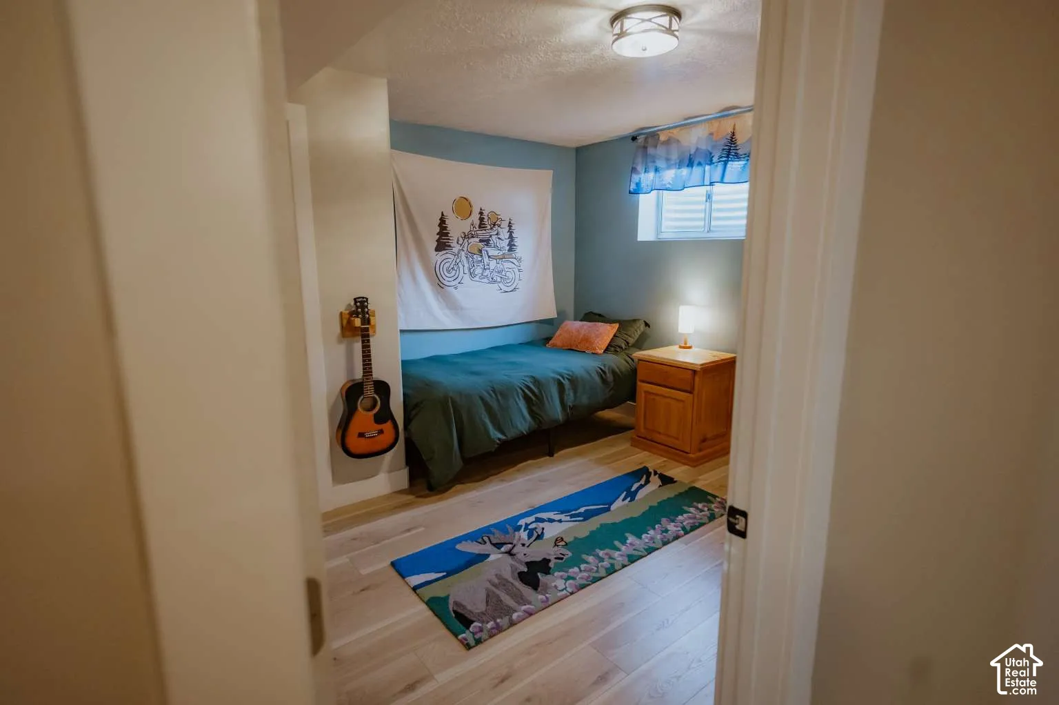 Room featuring light-toned wood-finish flooring, a recessed window, and a flush-mount ceiling light fixture