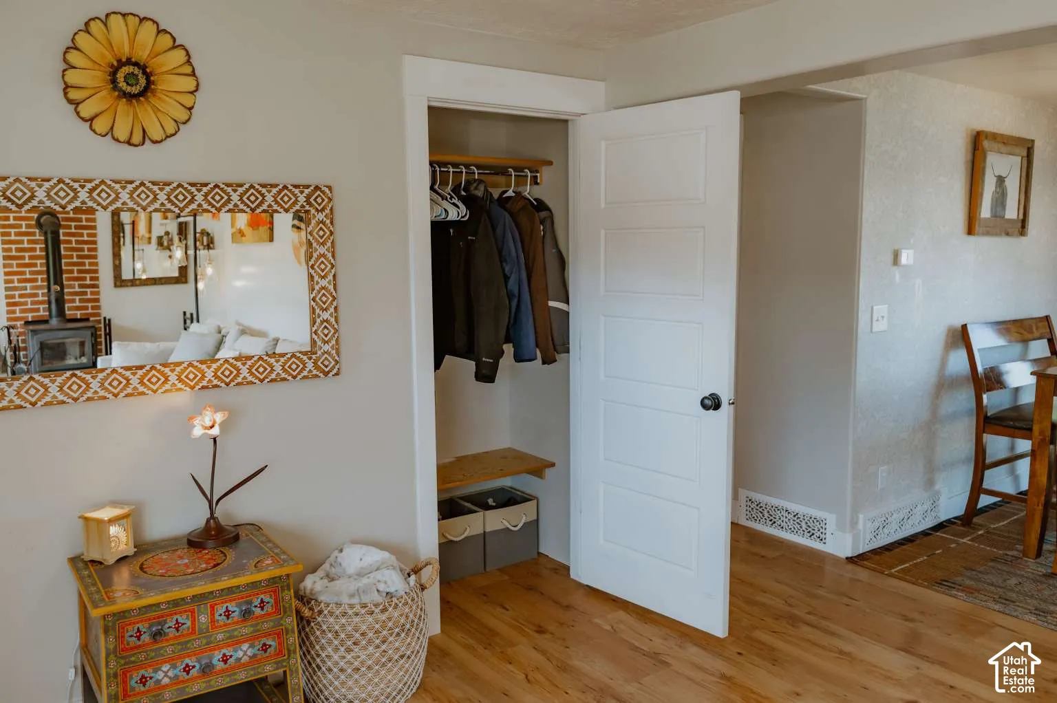 Interior space featuring wood-finish flooring, a five-panel interior door, and a built-in closet with integrated shelving