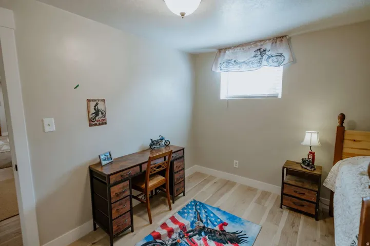 Light wood-finish flooring, recessed window, and overhead lighting