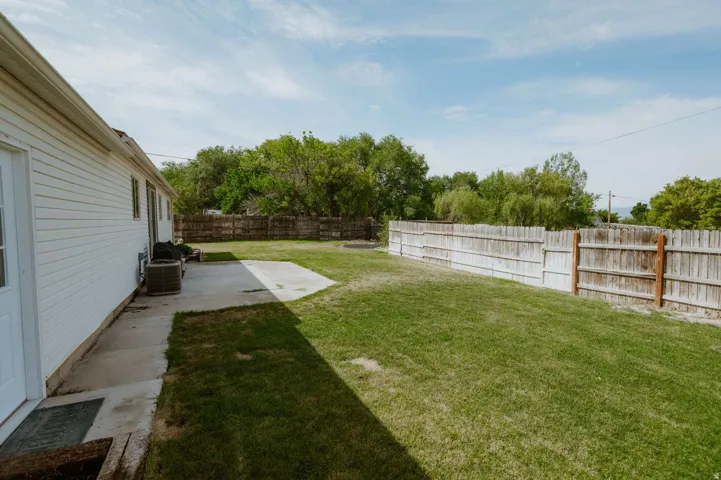 Expansive lawn area with a concrete patio