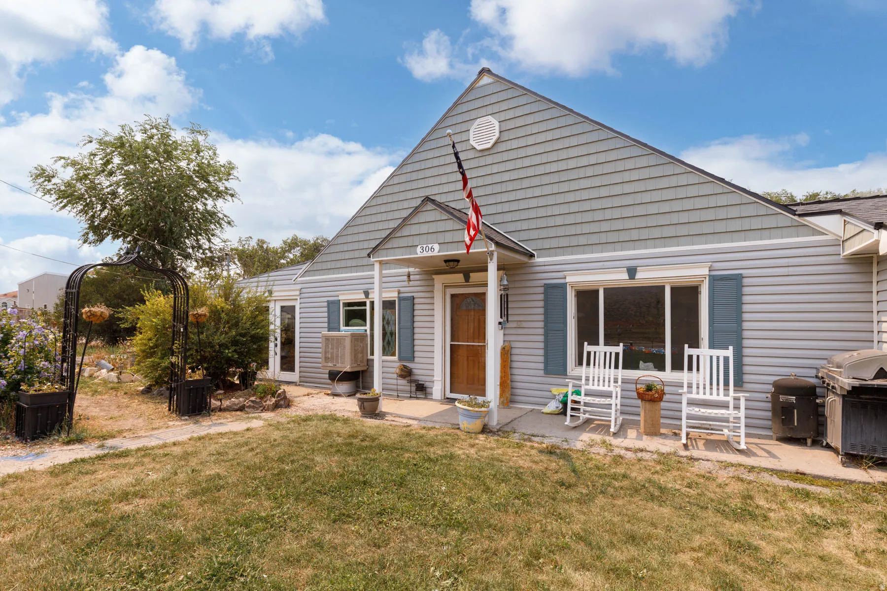 Front exterior with mixed siding, featuring horizontal siding and shake siding