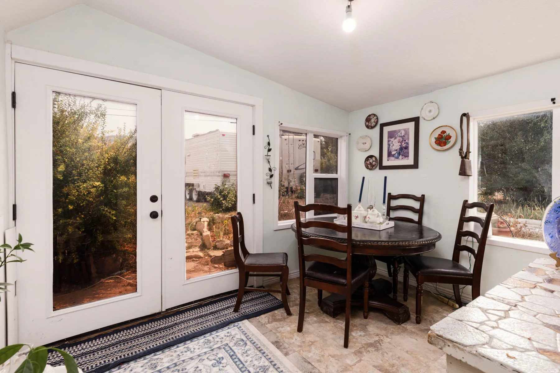 French doors with black hardware, surrounded by multiple windows