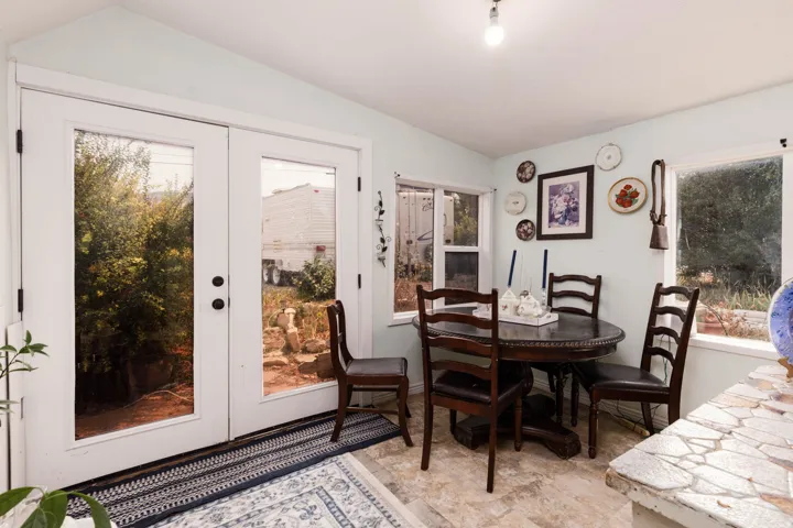 French doors with black hardware, surrounded by multiple windows