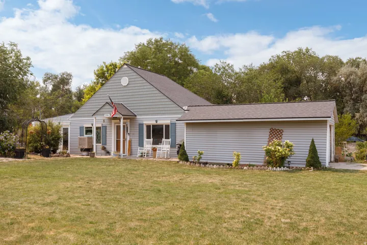 Light blue horizontal siding exterior with a gable roof, covered entry, and attached garage