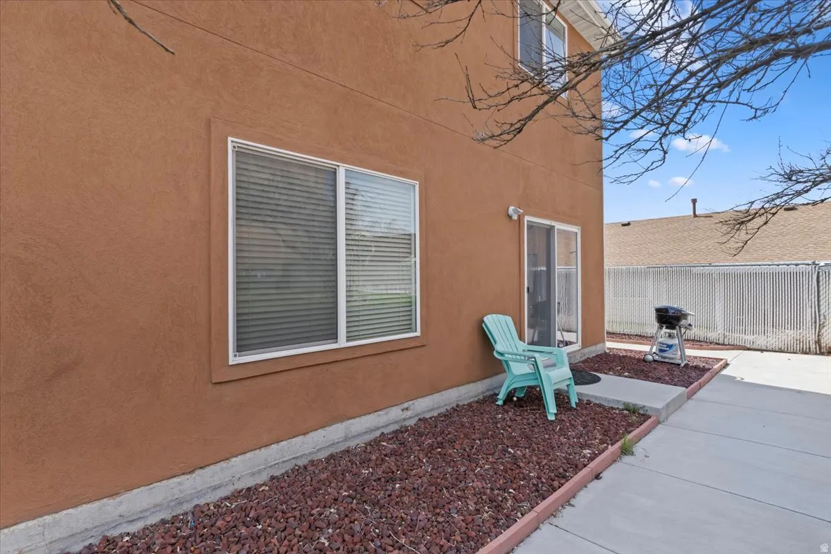 Terracotta stucco exterior with sliding glass doors and large picture windows featuring aluminum frames
