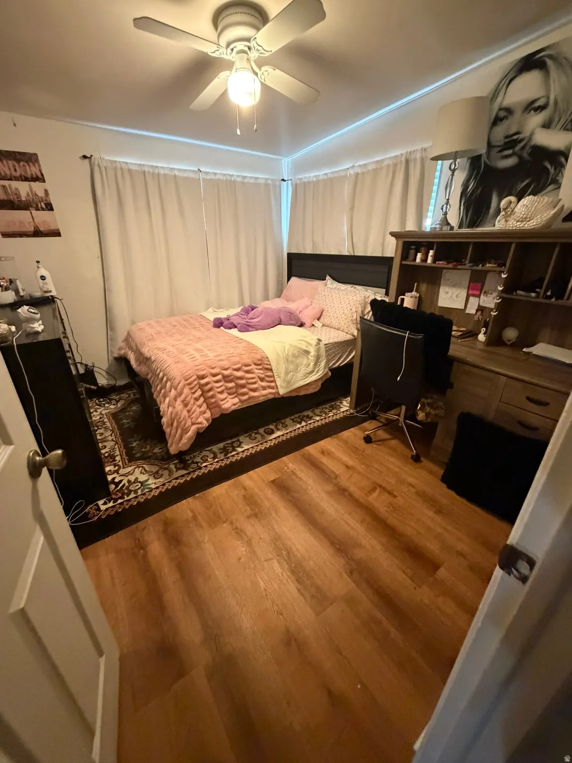 Wood-finish flooring with a ceiling fan light fixture