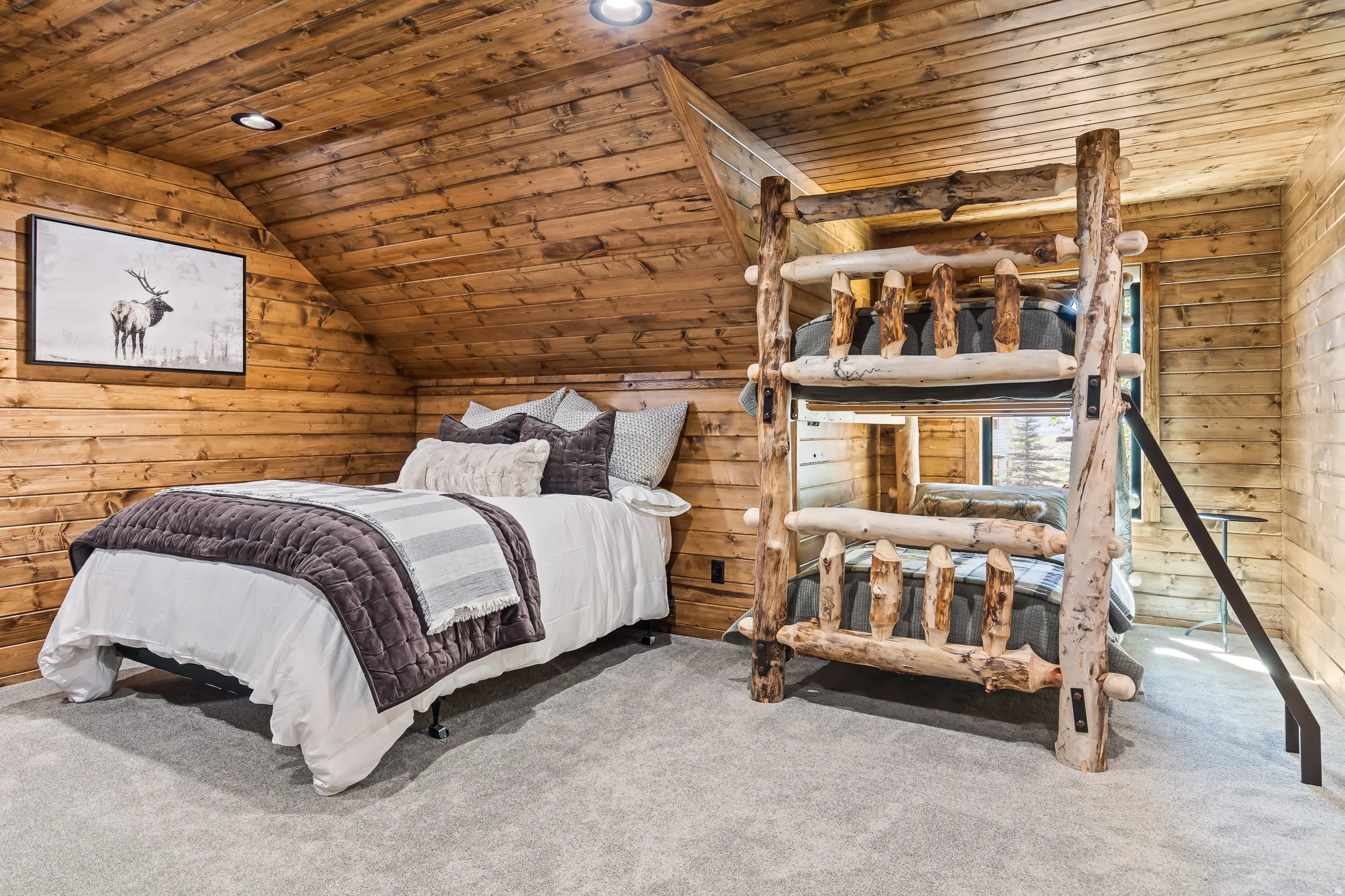 Wood-paneled walls and ceiling, recessed lighting, and soft gray carpeting