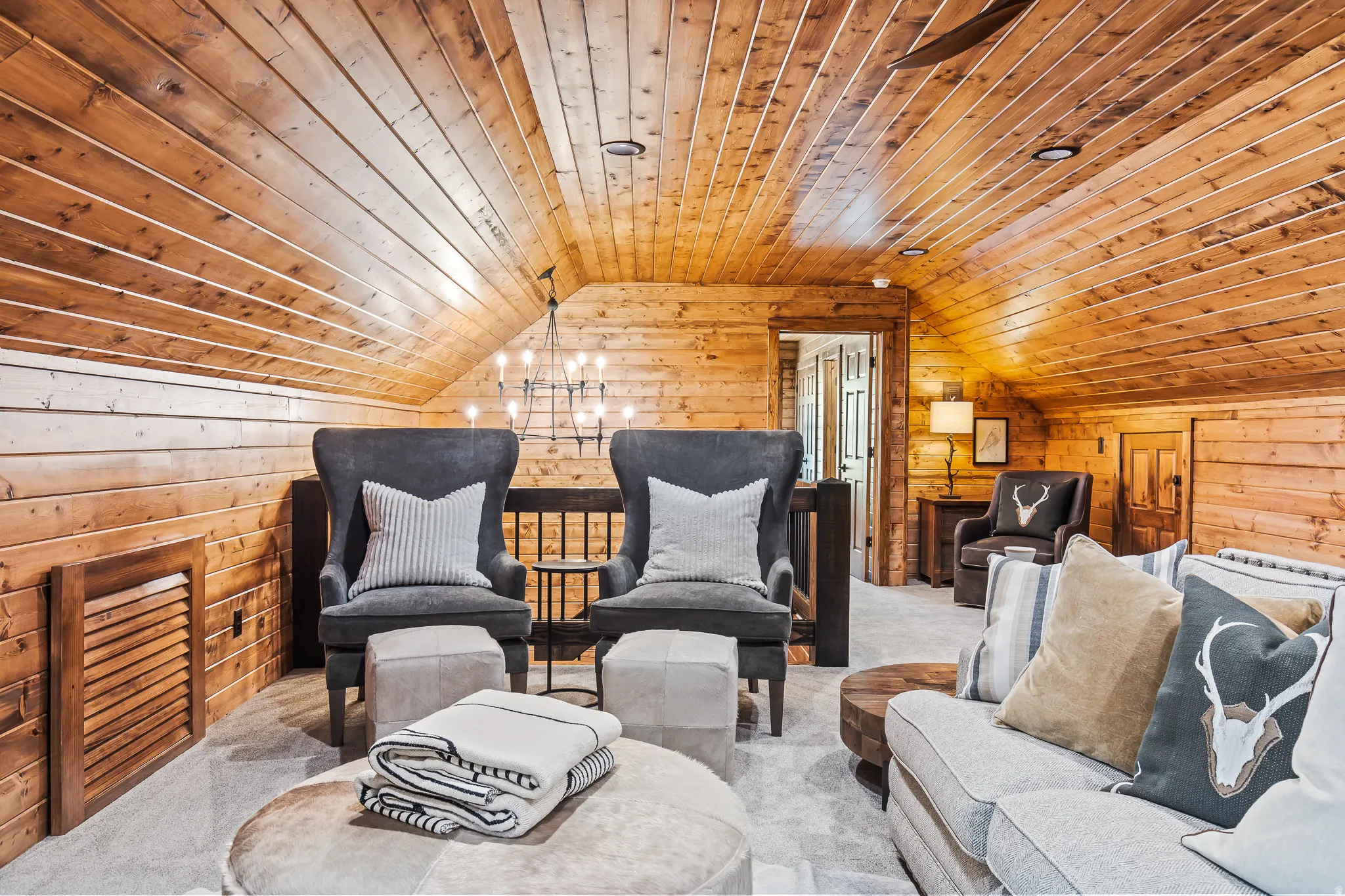 Wood-paneled walls and ceilings throughout, recessed lighting, and chandelier fixture