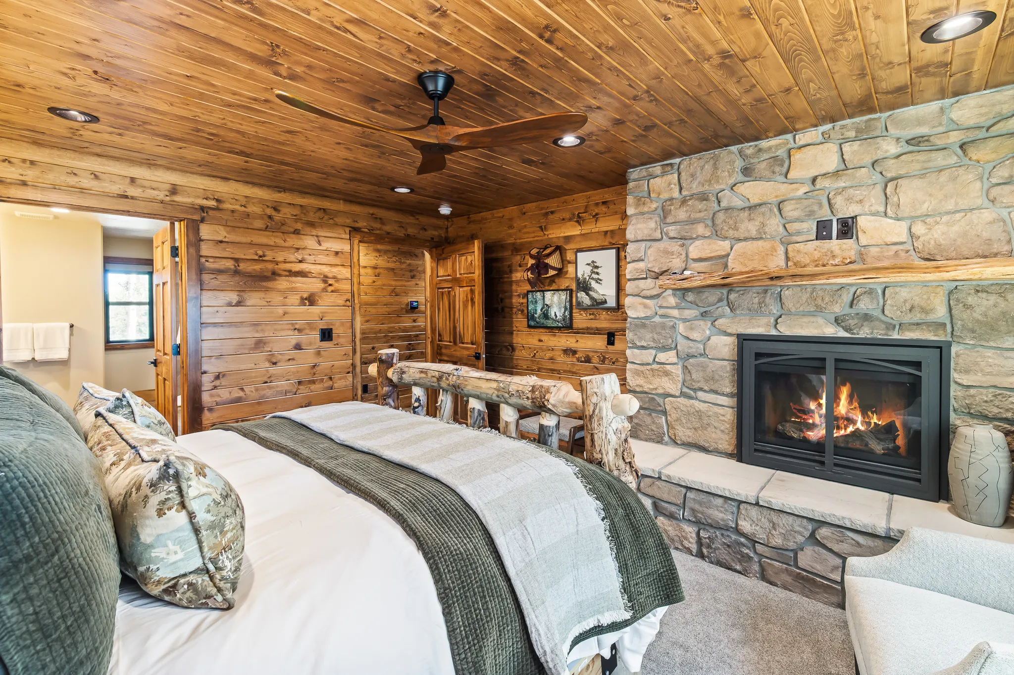 Stone-clad fireplace with a wood mantel