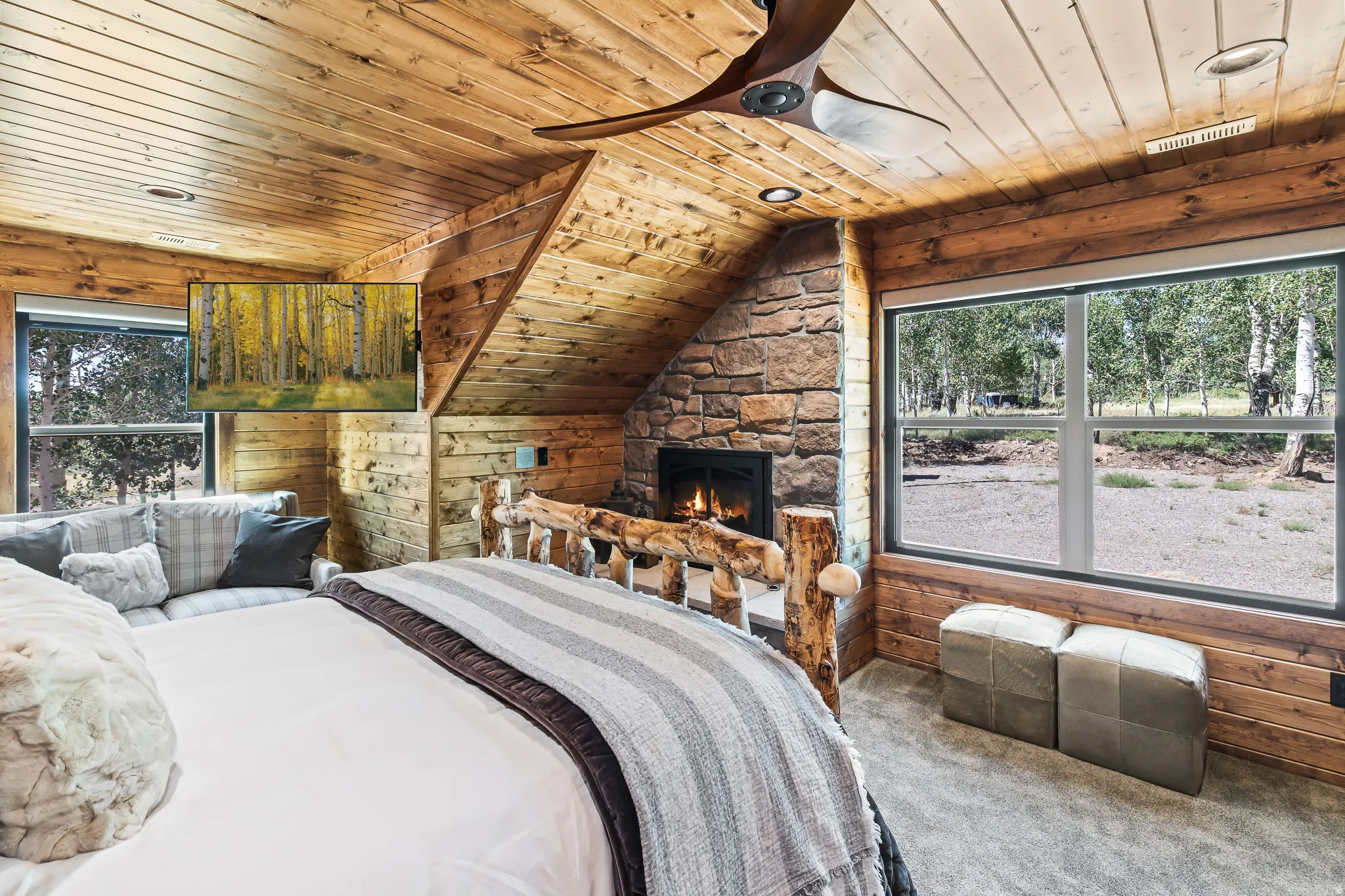 Wood-paneled walls and ceiling featuring a stone-clad fireplace