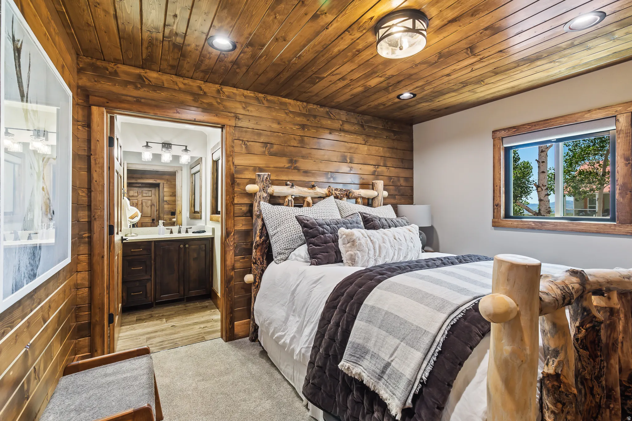 Wood-paneled walls and ceiling, recessed lighting, and a wood-framed window