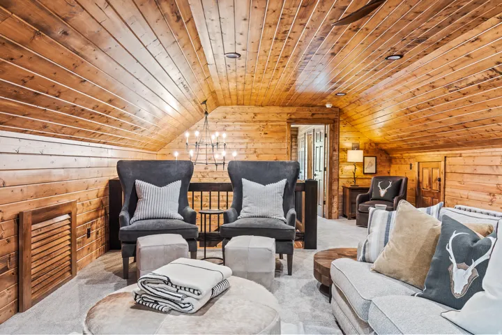 Wood-paneled walls and ceilings throughout, recessed lighting, and chandelier fixture