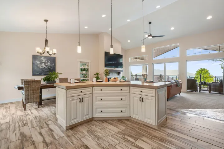 Vaulted ceilings, recessed lighting, and wood-finish flooring