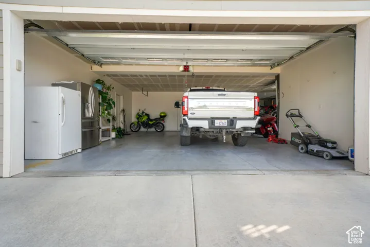 Spacious garage with light-colored walls and a concrete floor