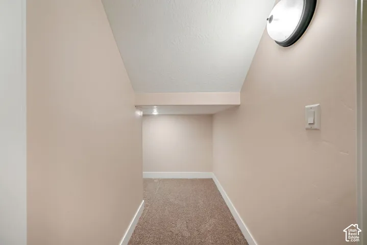Carpeted alcove with recessed lighting and a flush-mount ceiling fixture