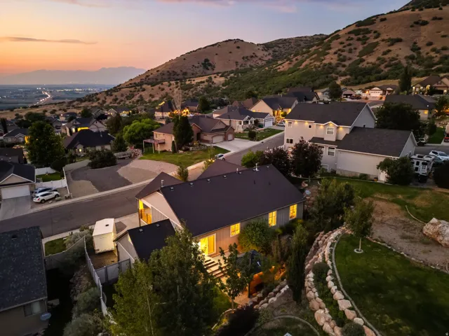 Hillside property with a terraced, rock-lined landscape and mature trees