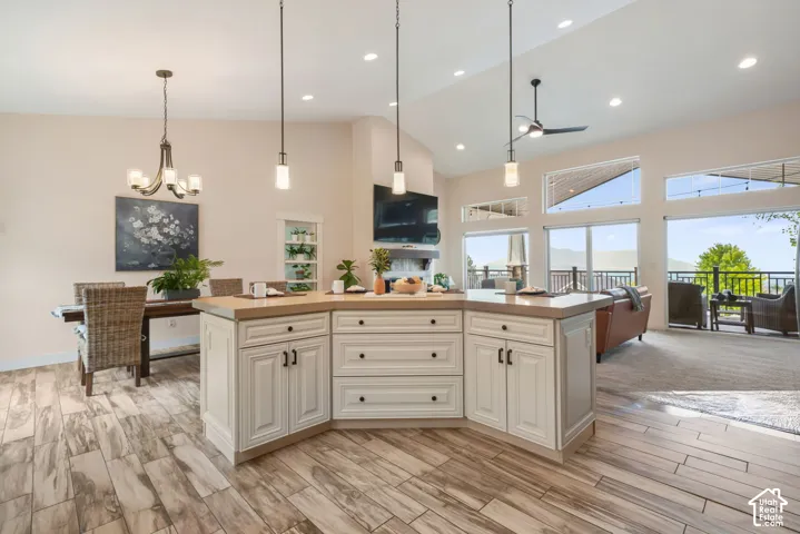 Vaulted ceilings, recessed lighting, and wood-finish flooring