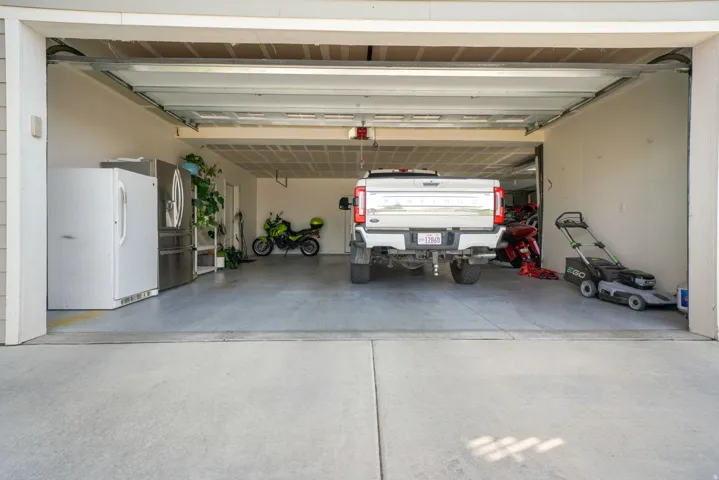 Spacious garage with light-colored walls and a concrete floor