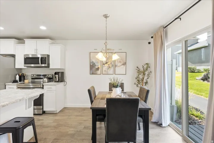 Kitchen featuring white cabinetry, stainless steel appliances, and a light-colored countertop