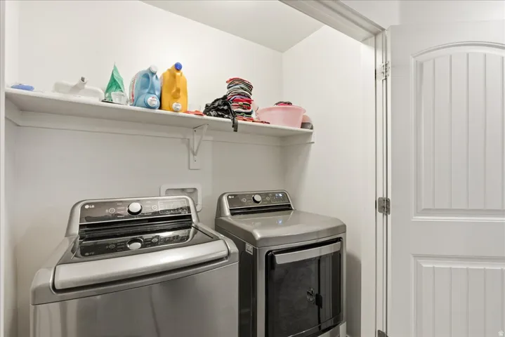 Utility space featuring a built-in shelf and a paneled interior door