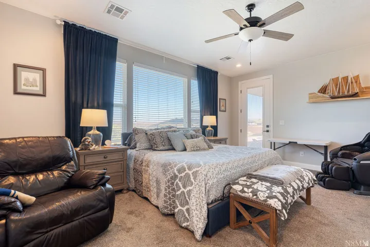Spacious room with large windows, a ceiling fan, recessed lighting, and direct outdoor access