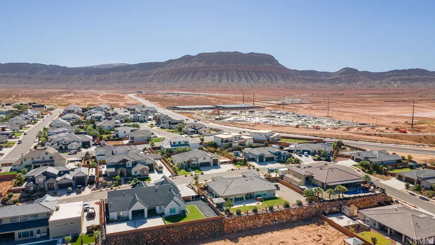 Residential neighborhood with diverse architectural styles, featuring paved streets and manicured landscaping
