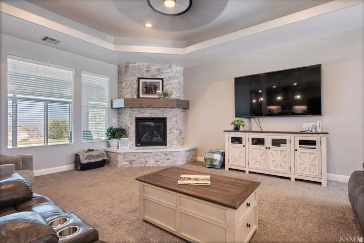 Corner fireplace with stone surround and wood mantel