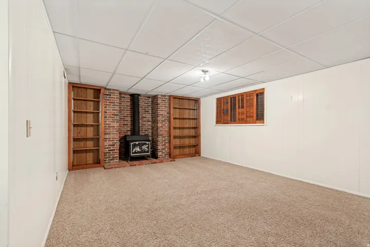 Brick fireplace featuring a wood-burning stove