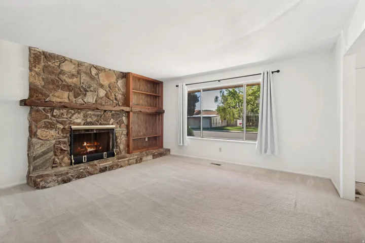Stone-clad fireplace with a wood mantel