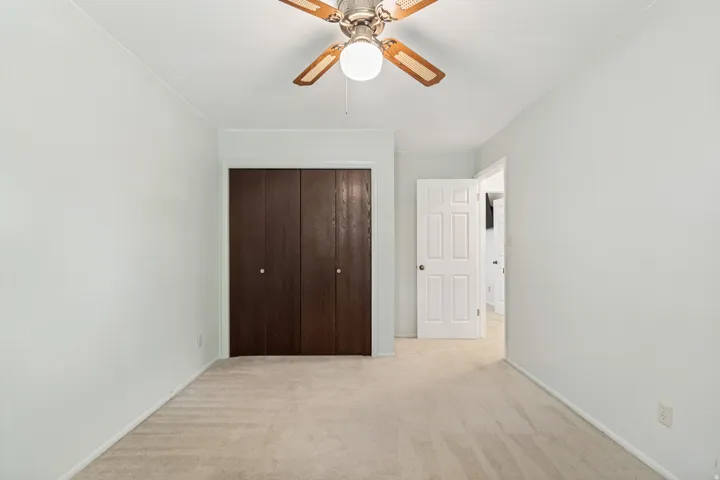 Neutral-toned carpeting paired with light-colored walls