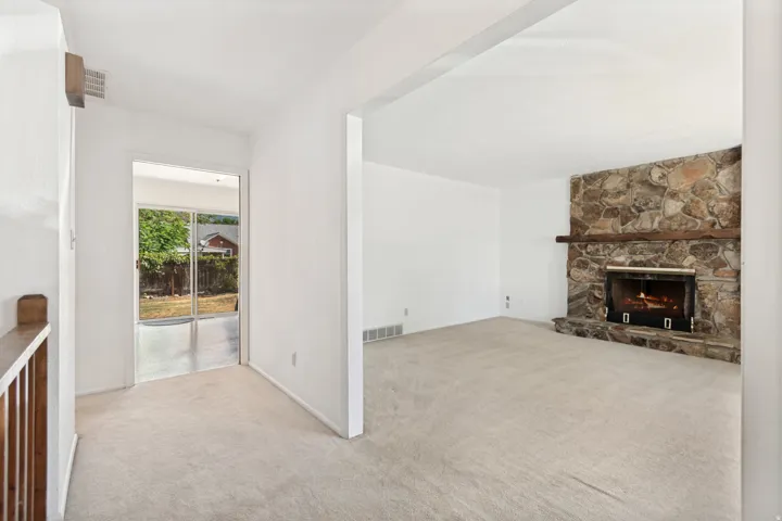 Stone-clad fireplace with a wood mantel