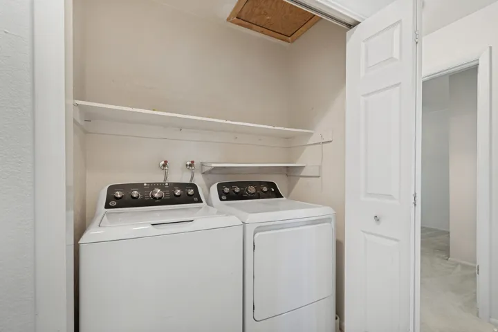Dedicated laundry area featuring a built-in shelf system